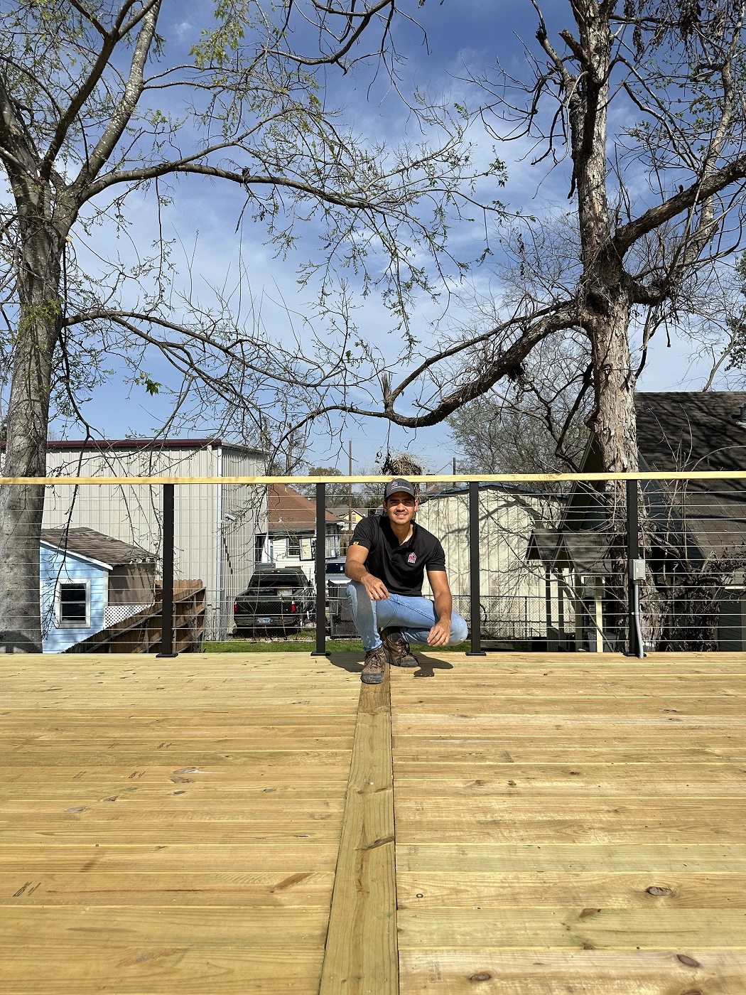 Iconic Upscale contractor on newly built wood deck with cable railing in Houston Texas