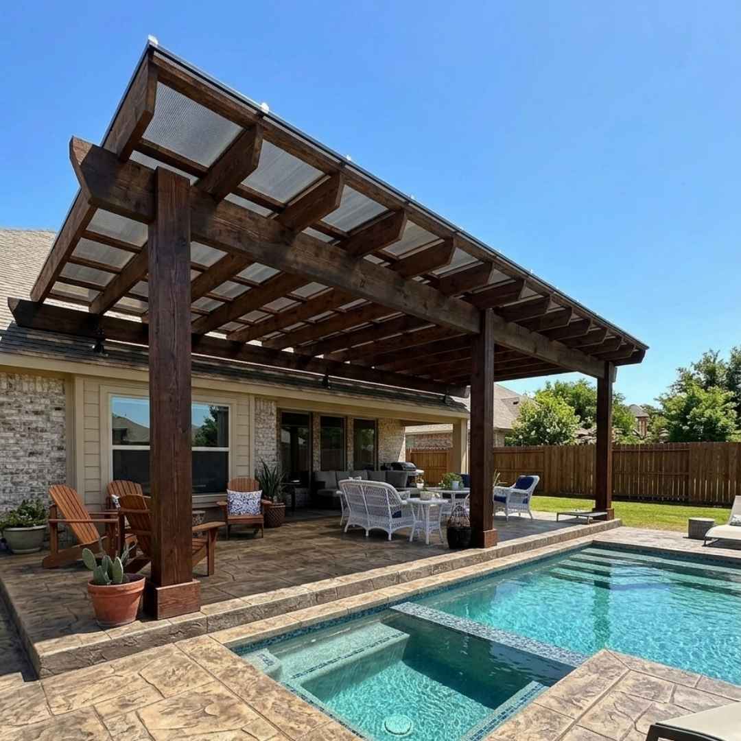 Outdoor living space featuring a cedar patio cover, stone-pattern stamped concrete, and custom pool design built in Cinco Ranch, Katy, TX.
